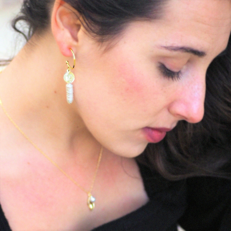 Woman wearing drop pearl earrings