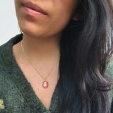 Model with lava necklace and green jumper