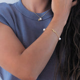 Model with starfish necklace and laurel and pearl bracelet